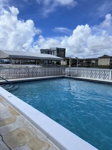 a view of a patio with table and chairs potted plants