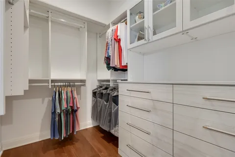 a view of walk in closet with clothes