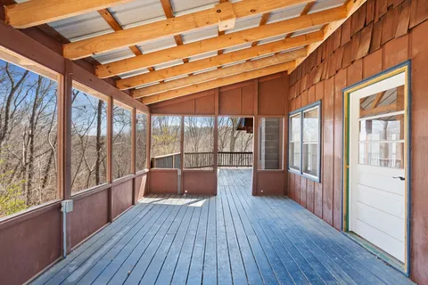 a view of balcony with wooden floor