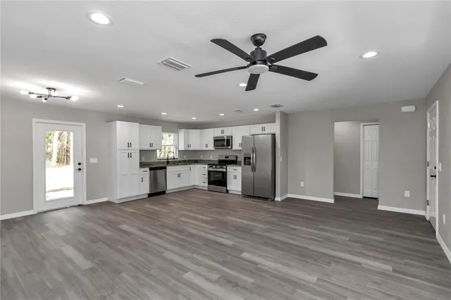 a view of a kitchen with a sink dishwasher and a window
