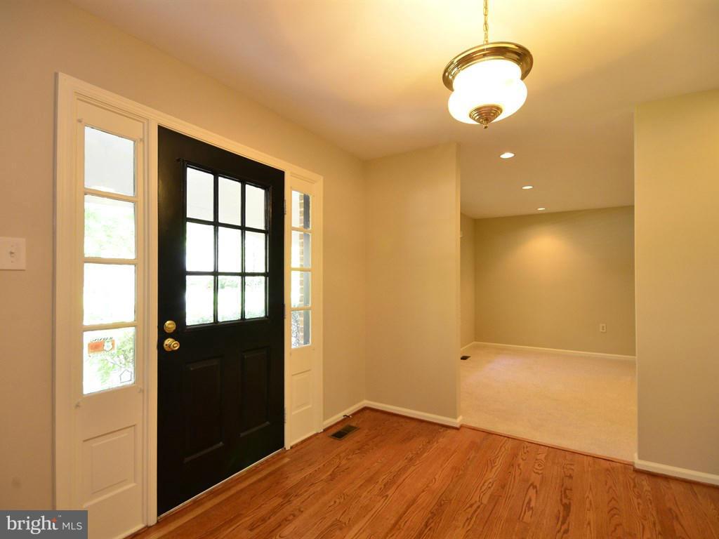 17 Pebble Ridge Court Potomac, MD 20854 - Photo 2 of 29 a view of empty room with wooden floor and windows