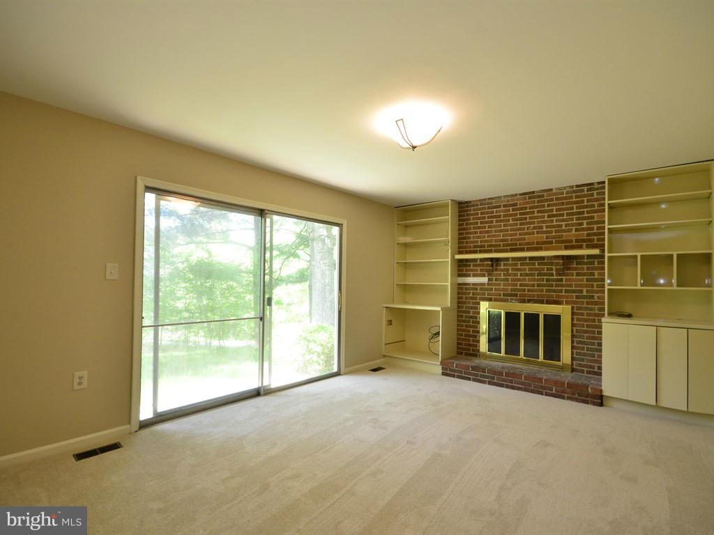 17 Pebble Ridge Court Potomac, MD 20854 - Photo 14 of 29 a view of an empty room with a fireplace and a window