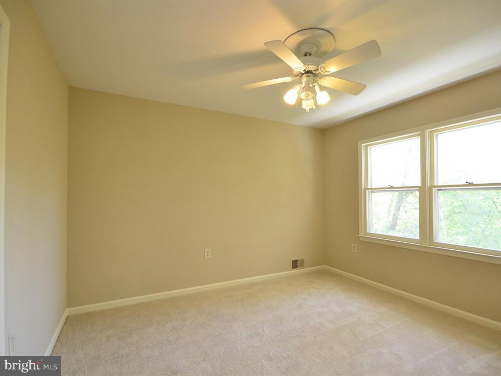 17 Pebble Ridge Court Potomac, MD 20854 - Photo 17 of 29 an empty room with a window and ceiling fan