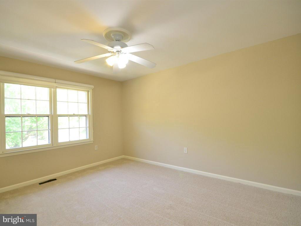 17 Pebble Ridge Court Potomac, MD 20854 - Photo 18 of 29 an empty room with a window and a fan
