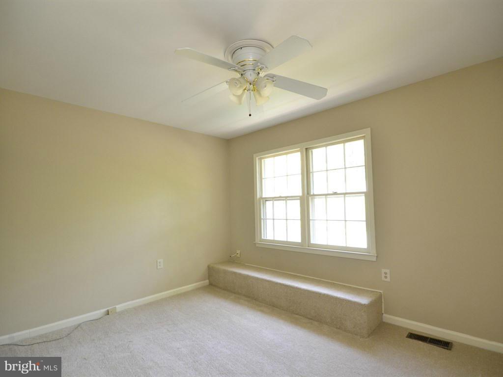 17 Pebble Ridge Court Potomac, MD 20854 - Photo 19 of 29 an empty room with a window and ceiling fan