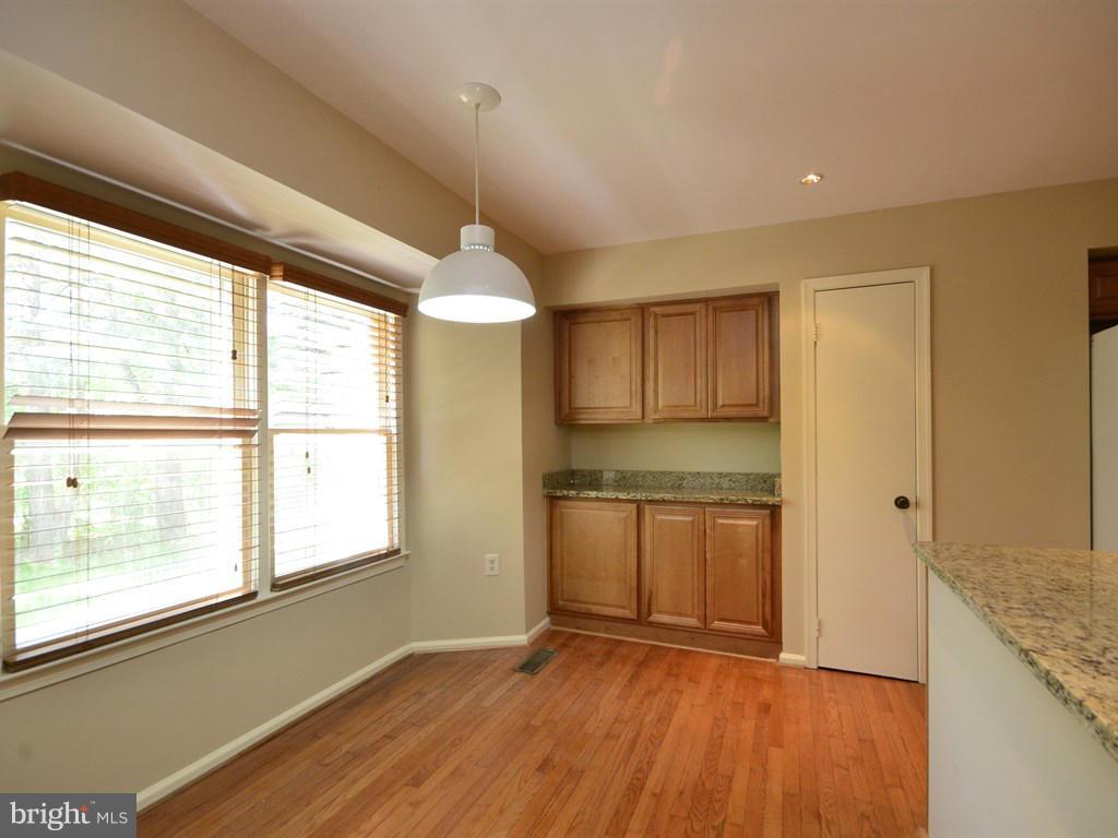17 Pebble Ridge Court Potomac, MD 20854 - Photo 7 of 29 a view of a kitchen with a sink and dishwasher with wooden floor