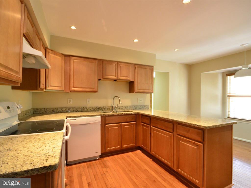 17 Pebble Ridge Court Potomac, MD 20854 - Photo 8 of 29 a kitchen with stainless steel appliances granite countertop wooden cabinets a sink and dishwasher