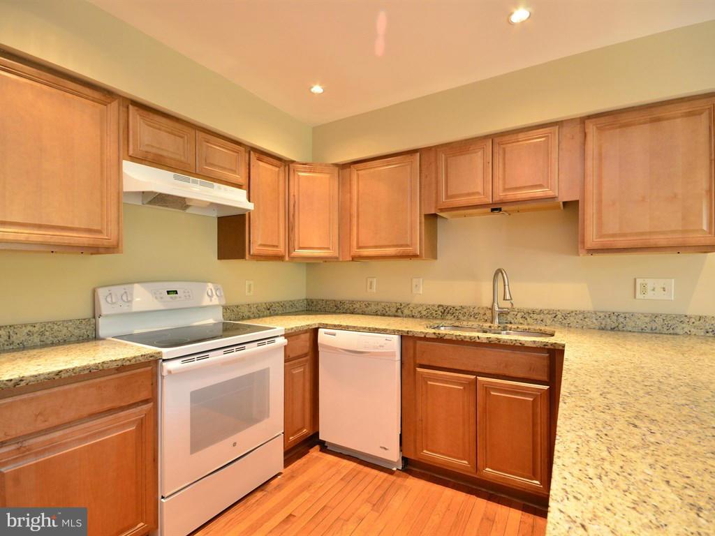 17 Pebble Ridge Court Potomac, MD 20854 - Photo 10 of 29 a kitchen with stainless steel appliances granite countertop a sink stove and cabinets