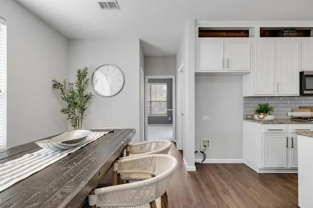 a kitchen with a sink a stove and cabinets