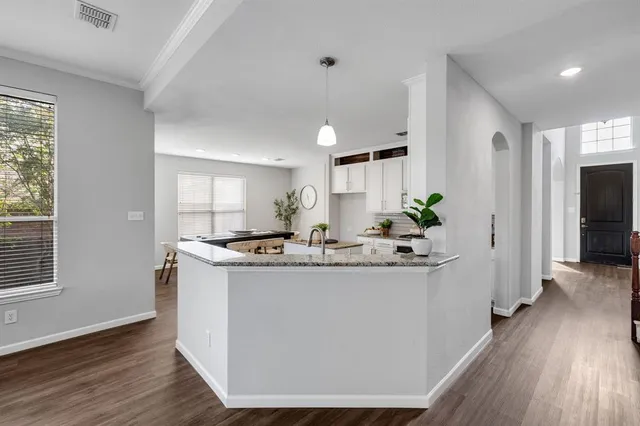 a view of kitchen with kitchen island wooden floor and center island