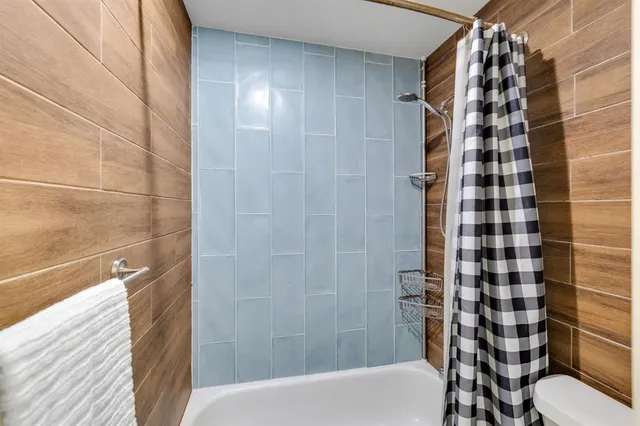 a bathroom with a bathtub and shower