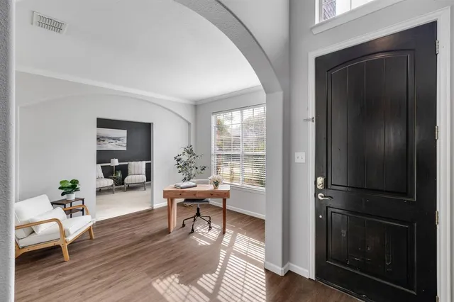 a living room with furniture and a wooden floor