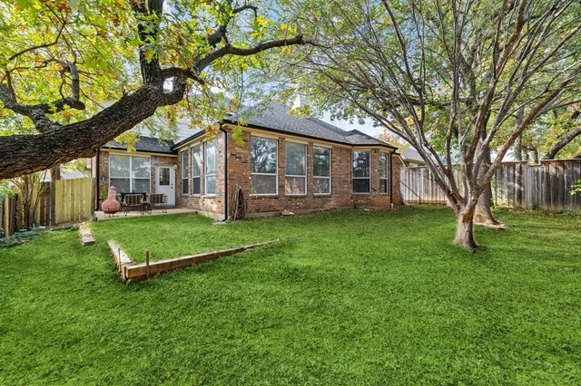 a view of a house with a backyard porch and sitting area