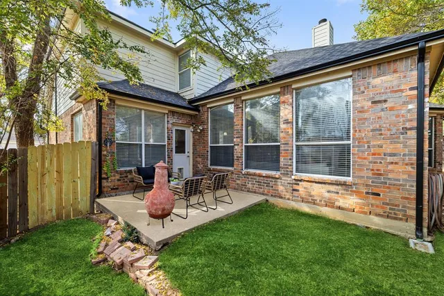 a backyard of a house with a garden and porch