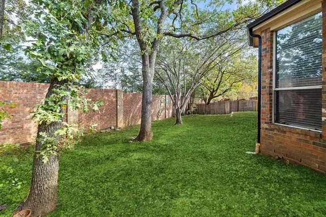 a view of a house with a backyard