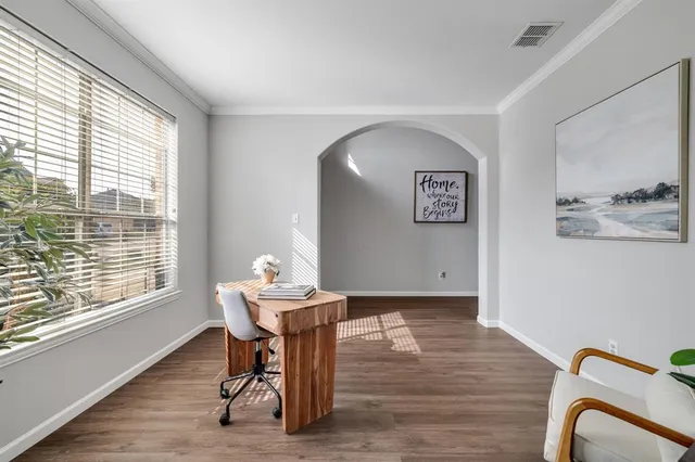 a view of a workspace with furniture and a window