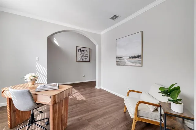 a view of a workspace room with furniture and wooden floor