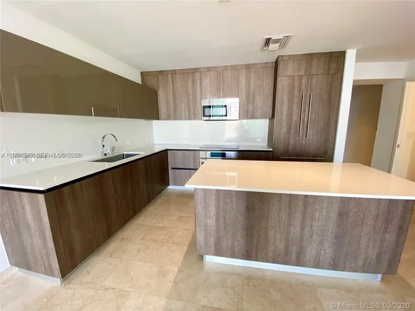 a room with a bed and a dresser