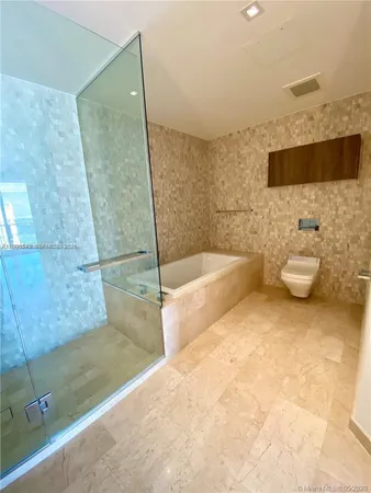 a bathroom with a bathtub and toilet