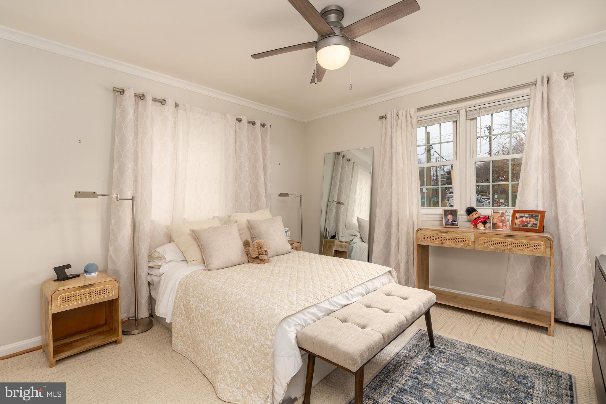 5050 Bradley Boulevard, Unit 6 Chevy Chase, MD 20815 - Photo 13 of 25 a bedroom with a bed and a chandelier