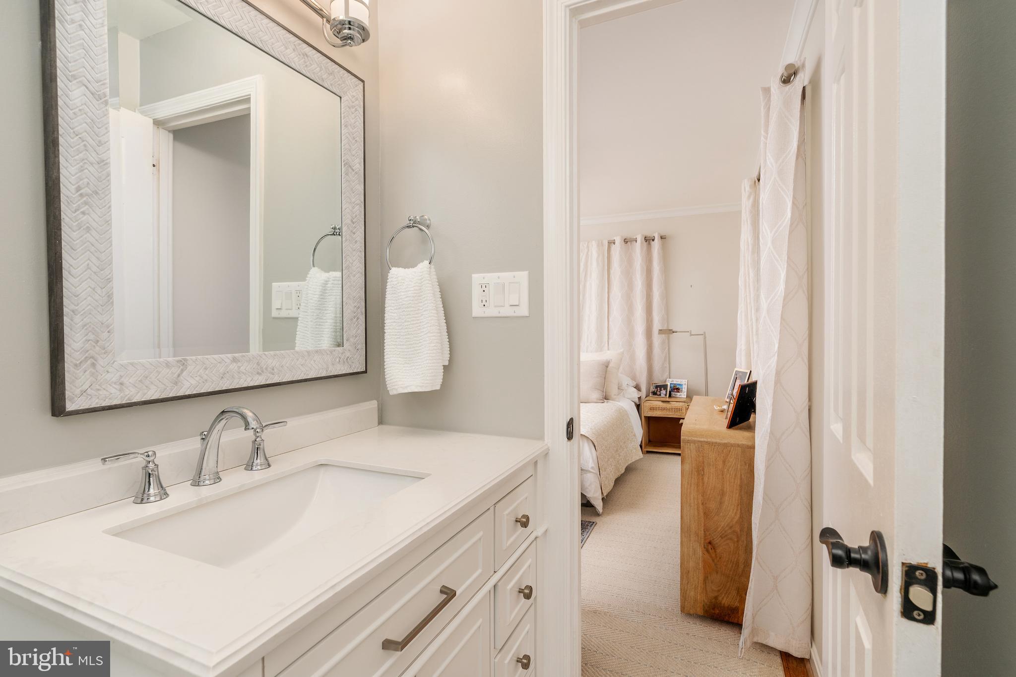 5050 Bradley Boulevard, Unit 6 Chevy Chase, MD 20815 - Photo 16 of 25 a en suite bathroom with a double vanity sink and mirror