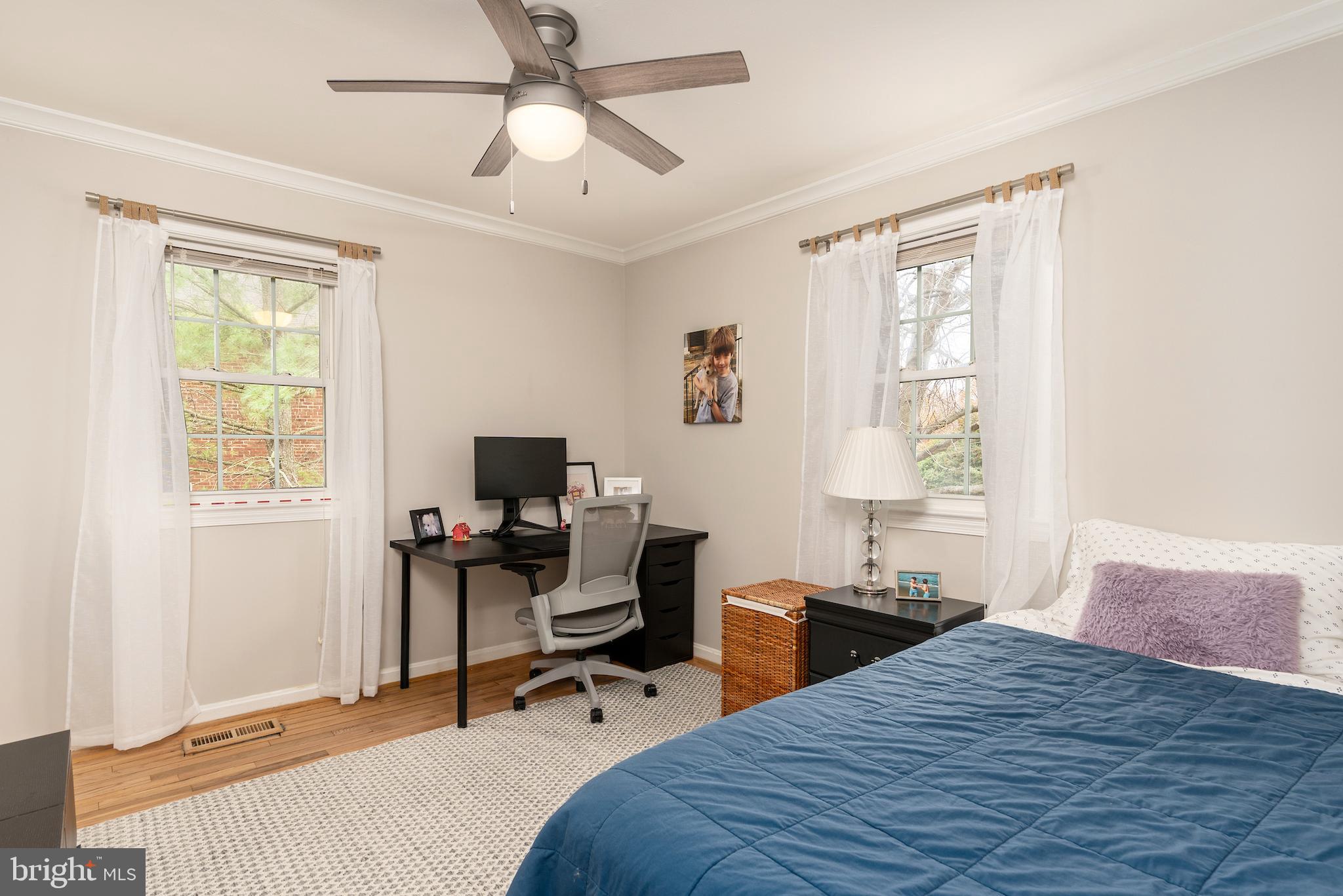 5050 Bradley Boulevard, Unit 6 Chevy Chase, MD 20815 - Photo 17 of 25 a bedroom that has a bed and a desk in it with a window
