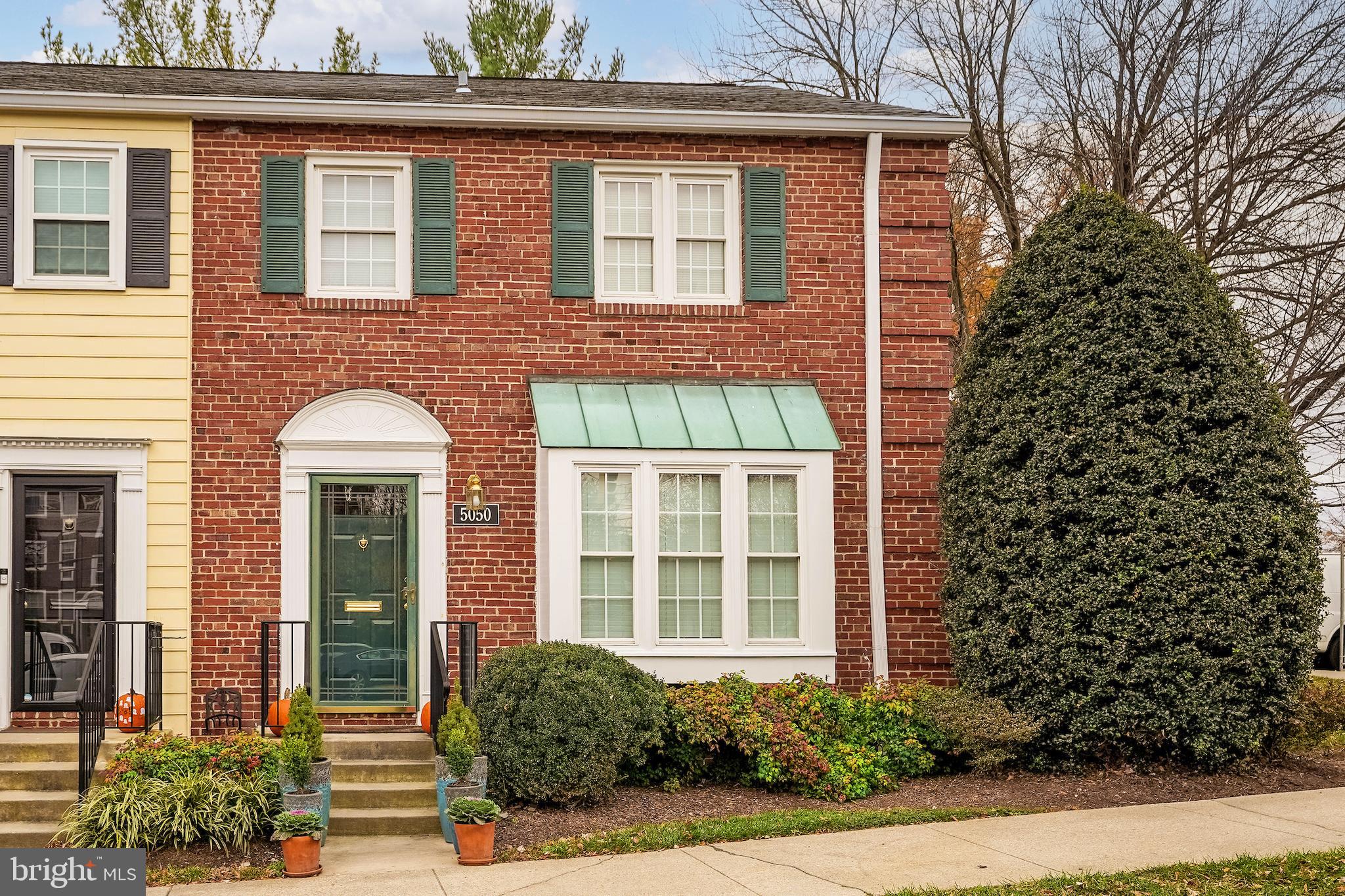 5050 Bradley Boulevard, Unit 6 Chevy Chase, MD 20815 - Photo 21 of 25 front view of a brick house with a large windows