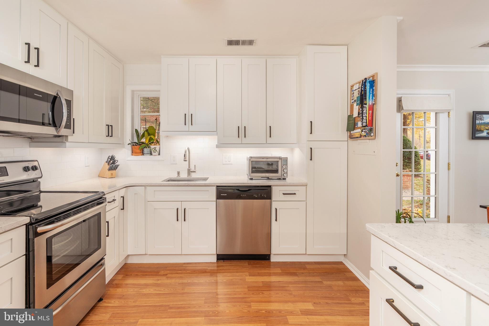 5050 Bradley Boulevard, Unit 6 Chevy Chase, MD 20815 - Photo 8 of 25 a kitchen with stainless steel appliances granite countertop a stove a sink and a refrigerator