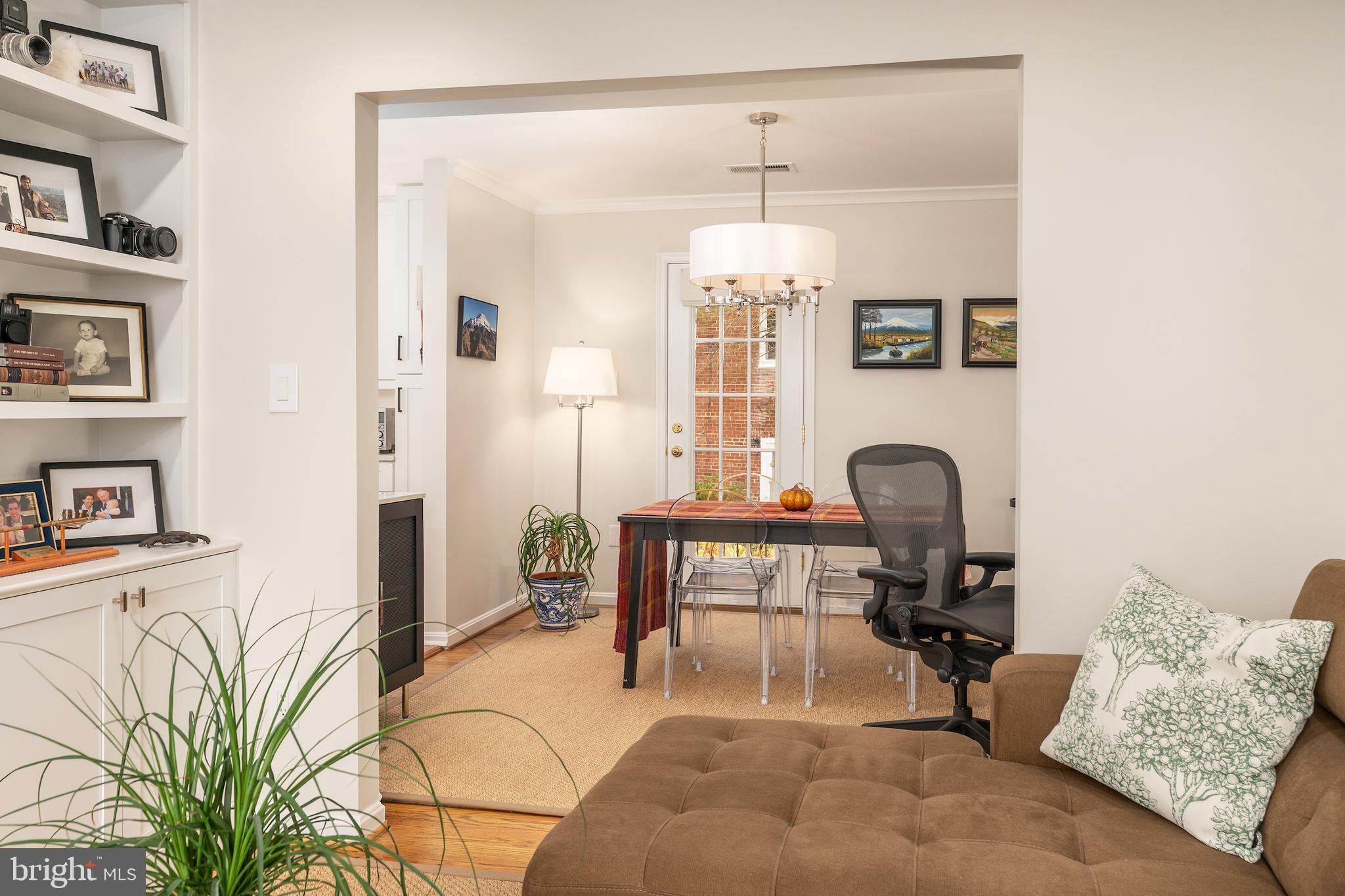 5050 Bradley Boulevard, Unit 6 Chevy Chase, MD 20815 - Photo 9 of 25 a living room with furniture and a chandelier