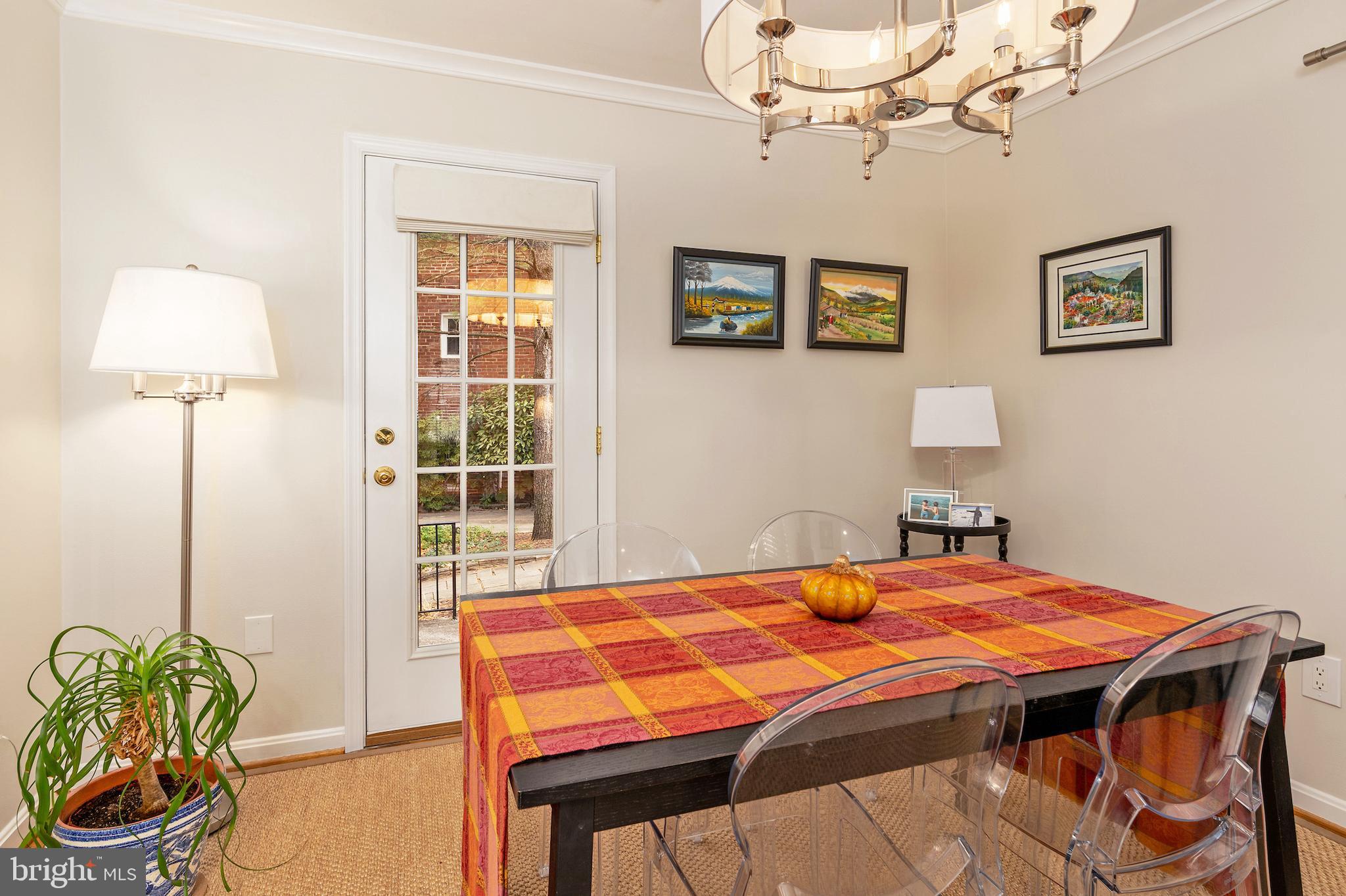 5050 Bradley Boulevard, Unit 6 Chevy Chase, MD 20815 - Photo 10 of 25 a bedroom with a bed and a chandelier