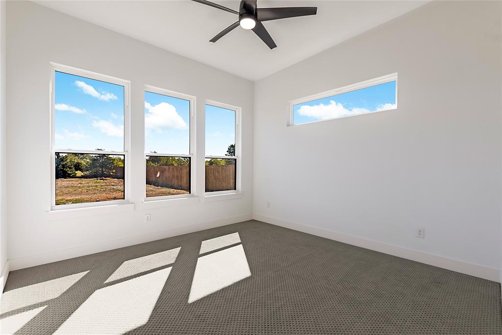 430 Whispering Way Red Oak, TX 75154 - Photo 34 of 40 Spacious room with high ceilings, featuring three vertical windows and one horizontal transom window