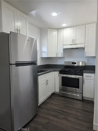 a white refrigerator freezer sitting in a kitchen