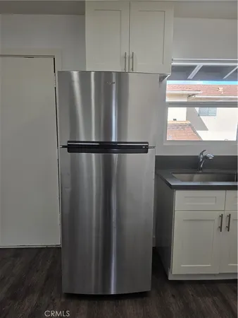 a white refrigerator freezer sitting inside of a kitchen