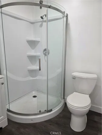 a bathroom with a toilet and a shower