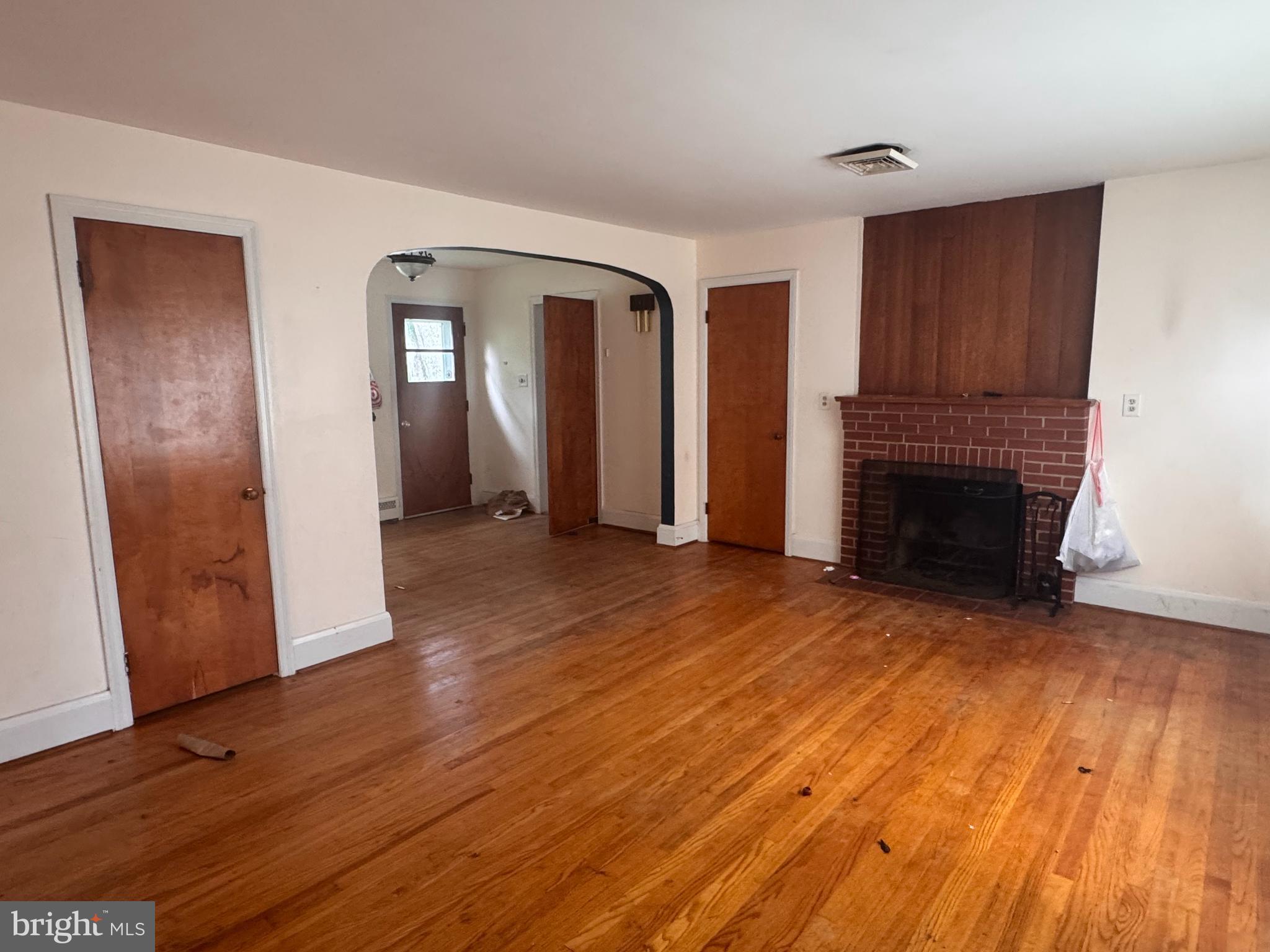 302 South Fountain Green Road Bel Air, MD 21015 - Photo 5 of 16 an empty room with wooden floor and fireplace