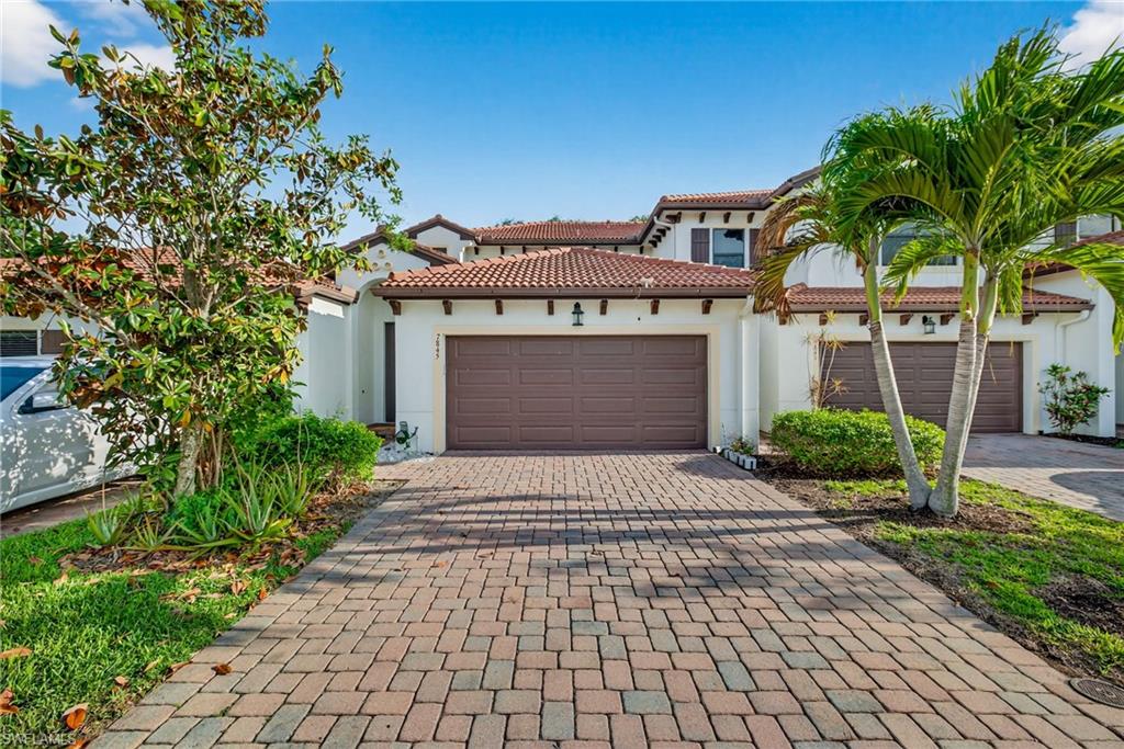 7845 Bristol Circle Naples, FL 34120 - Photo 1 of 31 a front view of a house with yard and parking