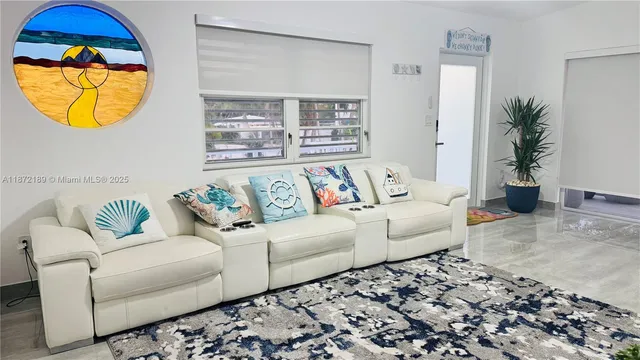 a living room with a couch and potted plant