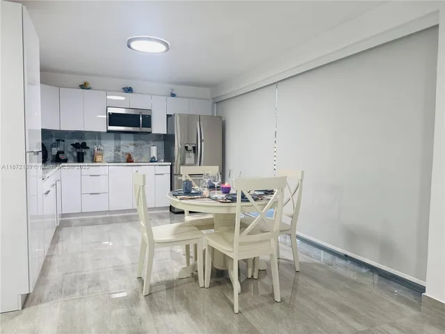 a kitchen with stainless steel appliances a microwave a stove a sink dishwasher and cabinets