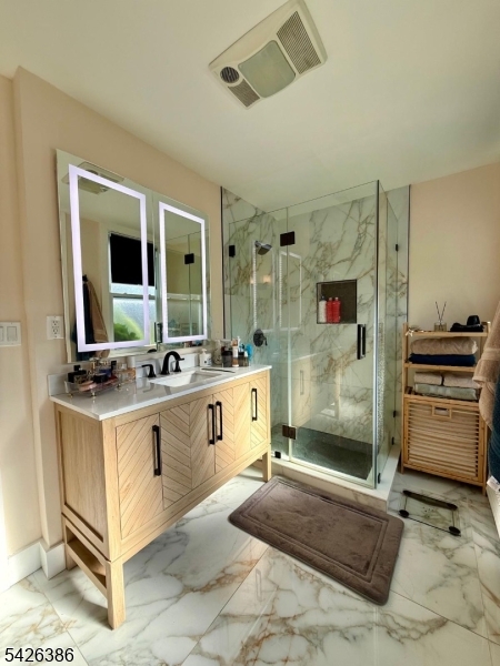195 Maple Street Kearny, NJ 07032 - Photo 13 of 24 a spacious bathroom with a sink a mirror and a shower
