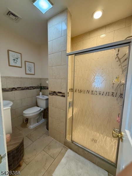 195 Maple Street Kearny, NJ 07032 - Photo 15 of 24 a bathroom with a toilet and a shower