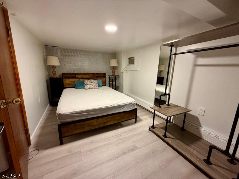 195 Maple Street Kearny, NJ 07032 - Photo 17 of 24 a bed room with a bed and a window