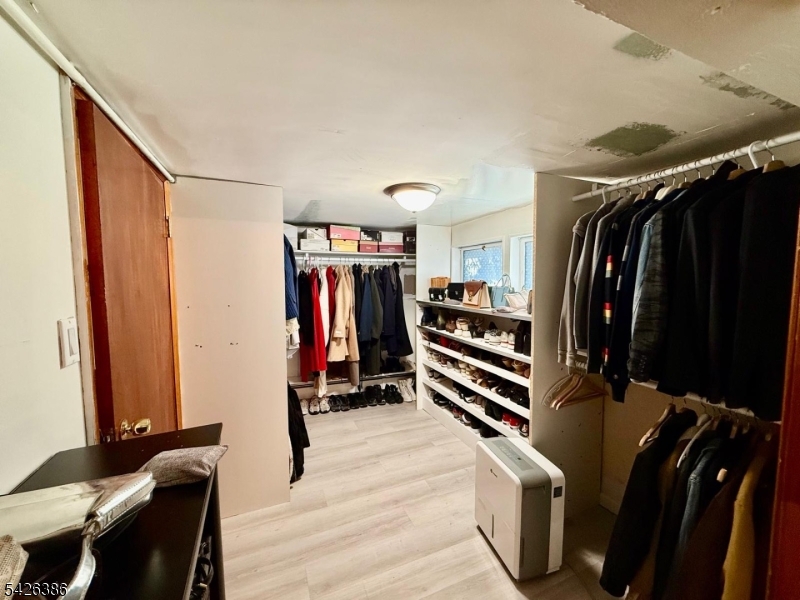195 Maple Street Kearny, NJ 07032 - Photo 19 of 24 a view of walk in closet with clothes and shoes