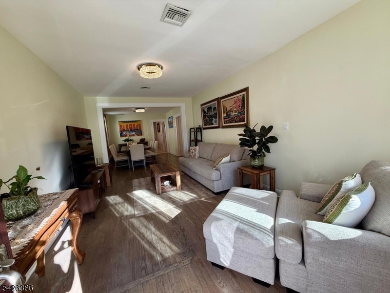 195 Maple Street Kearny, NJ 07032 - Photo 5 of 24 a living room with furniture and a flat screen tv