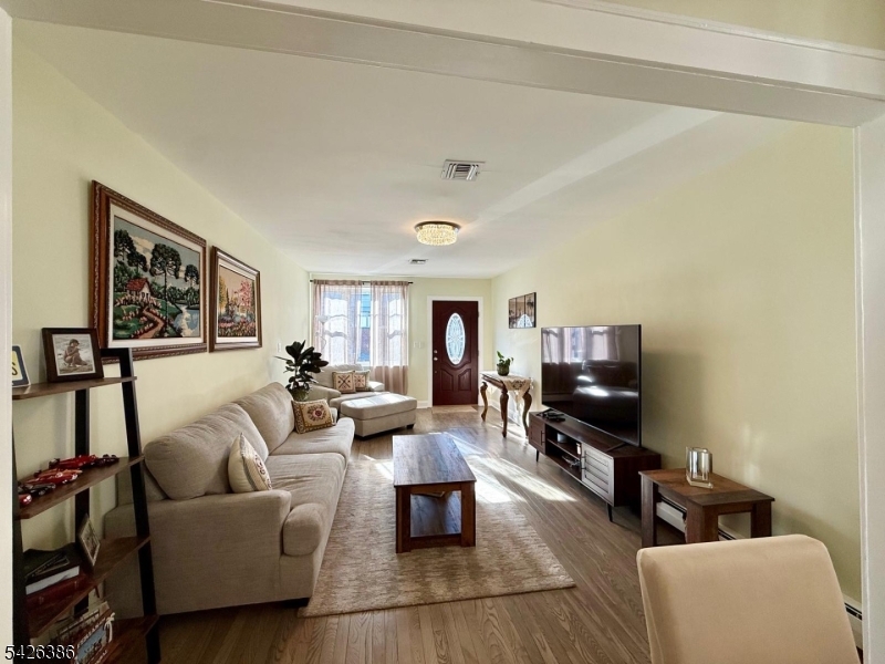 195 Maple Street Kearny, NJ 07032 - Photo 6 of 24 a living room with furniture and a flat screen tv