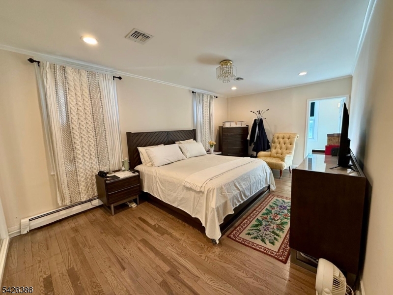 195 Maple Street Kearny, NJ 07032 - Photo 10 of 24 a bed room with a bed and a window