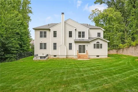 a view of a white house with a yard
