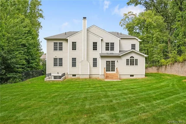 a view of a white house with a yard