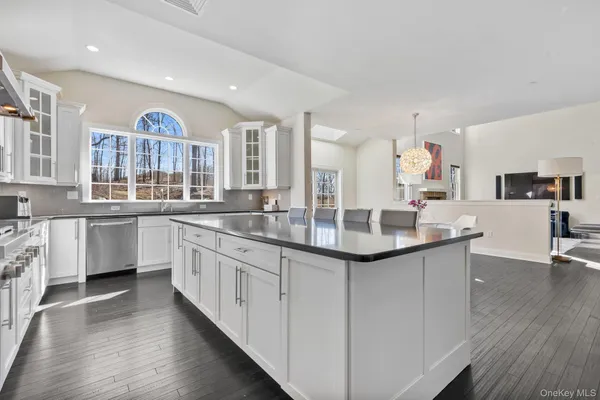a kitchen with stainless steel appliances granite countertop a sink and cabinets