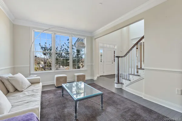 a living room with furniture and a painting on the wall