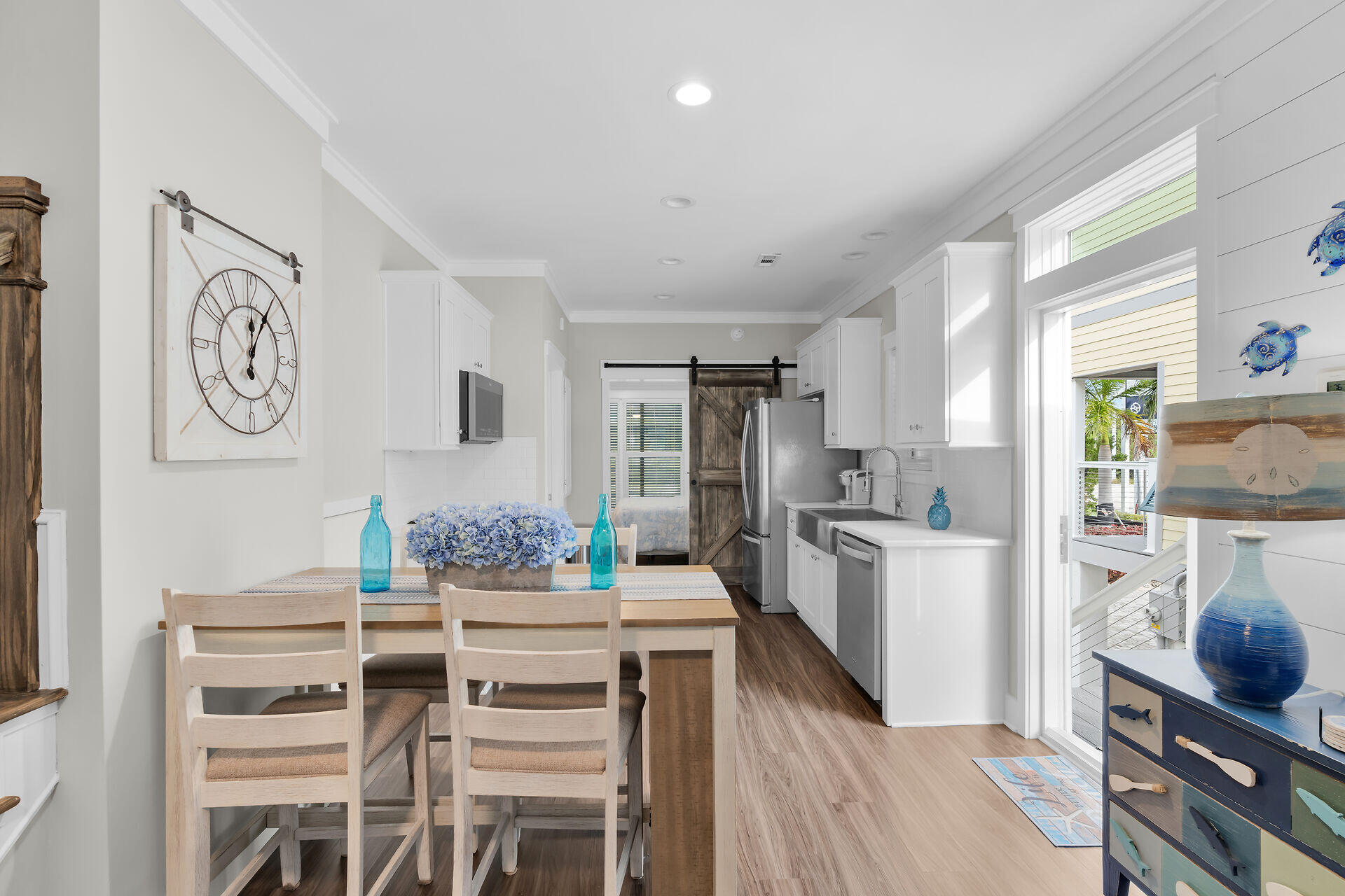 101 11th Street, Unit 19 Marathon, FL 33050 - Photo 6 of 27 a kitchen with stainless steel appliances kitchen island granite countertop a refrigerator a stove a sink and white cabinets with wooden floor